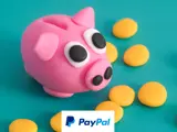 a playdough piggy bank and coins around it , with the paypal logo