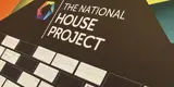 the national house project logo on a wall with notes underneath